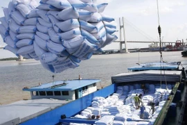 Bốc xếp gạo xuất khẩu sang tại cảng Sài Gòn. (Ảnh: TTXVN)