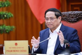 Thủ tướng Phạm Minh Chính chủ trì cuộc họp với ngành Ngân hàng về chính sách tiền tệ. (Ảnh: Dương Giang/TTXVN)