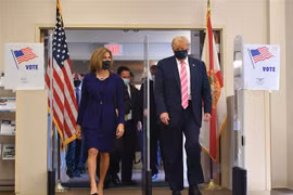 Tổng thống Mỹ đương nhiệm Donald Trump (phải) rời thư viện Palm Beach, Florida, nơi ông bỏ phiếu sớm trong cuộc bầu cử Tổng thống, ngày 24/10/2020. (Ảnh: AFP/TTXVN)