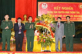 Tổng Giám đốc TTXVN Nguyễn Đức Lợi tặng hoa chúc mừng Bộ Tư lệnh Quân đoàn 2. (Ảnh: Dương Giang/TTXVN)