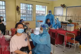 Tiêm vaccine phòng COVID-19 cho học sinh ở thành phố Thủ Dầu Một, tỉnh Bình Dương. (Ảnh: Văn Hướng/TTXVN)