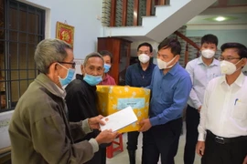 Thứ trưởng Bộ Nông nghiệp và Phát triển Nông thôn Nguyễn Hoàng Hiệp trao tiền hỗ trợ của Thủ tướng Phạm Minh Chính cho gia đình có người mất do mưa lụt gây ra tại Bình Định. (Ảnh: Tường Quân/TTXVN)