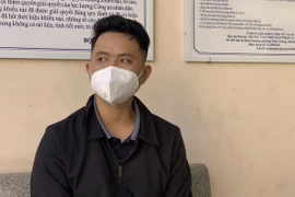 Đối tượng Nguyễn Đình Nhuận tại cơ quan chức năng. (Ảnh: TTXVN phát)