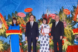 Đại diện Hội đồng chức danh giáo sư nhà nước trao chứng nhận cho các tân giáo sư, phó giáo sư. (Ảnh: Quý Trung/TTXVN)