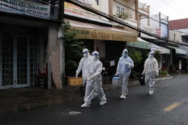 Nhân viên y tế đến địa bàn phường 4, thành phố Cà Mau- nơi xuất hiện chùm ca dương tính với SARS-CoV-2 để lấy mẫu xét nghiệm test nhanh cho tất cả người dân. (Ảnh: Kim Há/TTXVN)