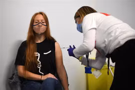 Nhân viên y tế tiêm vaccine ngừa COVID-19 cho người dân tại London, Anh, ngày 25/6/2021. (Ảnh: AFP/TTXVN)