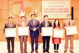 Đồng chí Nguyễn Hạnh Phúc,Tổng Thư ký, Chủ nhiệm Văn phòng Quốc hội trao Huân chương Lao động các hạng cho các tập thể, cá nhân. (Ảnh: Trọng Đức/TTXVN)