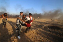 Chuyển người biểu tình Palestine bị thương trong cuộc xung đột với binh lính Israel tại khu vực biên giới Dải Gaza-Israel ngày 21/9. (Ảnh: THX/TTXVN)