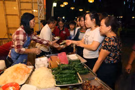 Người dân tham quan và mua món ăn tại các gian hàng ẩm thực. (Ảnh: Thành Đạt/TTXVN)