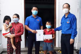 Tỉnh Đoàn và Hội đồng Đội tỉnh Phú Yên tặng học bổng nhận đỡ đầu trẻ mồ côi mẹ vì dịch COVID-19. (Ảnh: TTXVN)