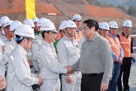 Thủ tướng Phạm Minh Chính động viên kỹ sư, công nhân thi công mở rộng Nhà máy Thủy điện Hòa Bình. (Ảnh: Dương Giang/TTXVN)