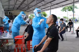 Lực lượng y tế lấy mẫu xét nghiệm virus SARS-CoV-2. (Ảnh: Hoàng Ngọc/TTXVN)