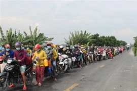 Rất đông người dân từ các vùng dịch trở về các tỉnh miền Tây, trong đó có Đồng Tháp bằng phương tiện xe máy. (Ảnh: Chương Đài/TTXVN)