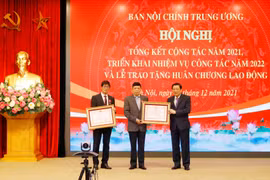 Ông Phan Đình Trạc, Ủy viên Bộ Chính trị, Bí thư Trung ương Đảng, Trưởng Ban Nội chính Trung ương trao Huân chương Lao động cho các cá nhân. (Ảnh: Phương Hoa/TTXVN)