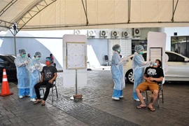 Nhân viên y tế lấy mẫu xét nghiệm COVID-19 tại Bangkok, Thái Lan. (Ảnh: AFP/TTXVN)