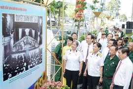 Lãnh đạo Thành phố Hồ Chí Minh cùng các đại biểu tham quan triển lãm. (Ảnh: Thu Hương/TTXVN)