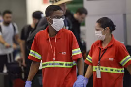 Nhân viên hàng không đeo khẩu trang tại sân bay Sao Paulo. (Ảnh: AP)