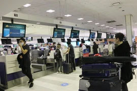 Công dân làm thủ tục tại sân bay quốc tế Sydney. (Ảnh: TTXVN)