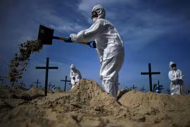 Các tình nguyện viên đào mộ trên bãi biển Copacabana. (Ảnh: AFP)
