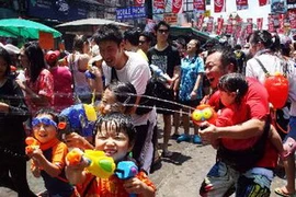 Người dân Thái Lan té nước cầu chúc may mắn trong Tết Songkran ở thủ đô Bangkok ngày 13/4. (Nguồn: THX/TTXVN)