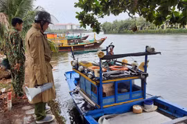 Các lực lượng chức năng Quảng Nam hướng dẫn người dân neo đậu tàu thuyền phòng, chống bão số 5. (Ảnh: Trần Tĩnh/TTXVN)