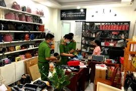 Lực lượng chức năng kiểm tra cửa hàng kinh doanh túi xách bắt giữ lô công cụ hỗ trợ cực lớn. (Ảnh: TTXVN phát)