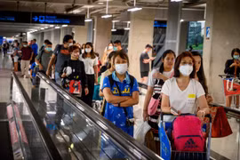 Hành khách đeo khẩu trang phòng lây nhiễm bệnh viêm đường hô hấp cấp COVID-19 tại sân bay ở Bangkok, Thái Lan. (Ảnh: AFP/TTXVN)