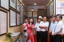 Thứ trưởng Bộ Thông tin và Truyền thông Nguyễn Minh Hồng (thứ 2 từ phải sang) và cán bộ, chiến sỹ Bộ Tư lệnh Vùng 1 Hải quân tham quan triển lãm. (Ảnh: Lâm Khánh/TTXVN) 