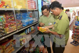Lực lượng quản lý thị trường kiểm tra tại một cửa hàng kinh doanh. (Ảnh: Vũ Sinh/TTXVN)