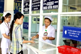 Thanh toán viên phí bằng Bảo hiểm y tế. (Ảnh: Dương Ngọc/TTXVN)