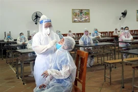 Lấy mẫu xét nghiệm cho công nhân. (Ảnh: Trần Trang/TTXVN)