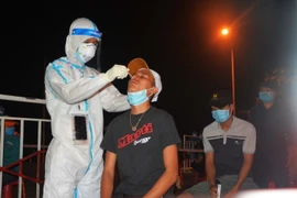 Lấy mẫu xét nghiệm cho người dân Cảng cá Thọ Quang. (Ảnh: Văn Dũng/TTXVN)