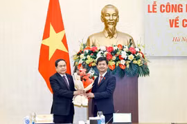Chủ tịch Quốc hội Trần Thanh Mẫn trao Nghị quyết, tặng hoa cho Tổng Thư ký Quốc hội Lê Quang Tùng. (Ảnh: Doãn Tấn/TTXVN)