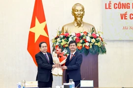 Chủ tịch Quốc hội Trần Thanh Mẫn trao Nghị quyết, tặng hoa cho Tổng Thư ký Quốc hội Lê Quang Tùng. (Ảnh: Doãn Tấn/TTXVN)