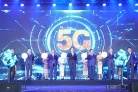 Các đại biểu nhấn nút khai trương kinh doanh dịch vụ 5G tại Lào. (Ảnh: Đỗ Bá Thành/TTXVN)