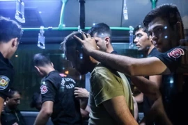 Cảnh sát chống bạo động Thổ Nhĩ Kỳ áp giải các binh sĩ bị bắt tới tòa án ở Istanbul ngày 16/7. (Nguồn: AFP/TTXVN)