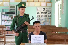 Đối tượng Khà A Hua bị bắt tại cơ quan chức năng. (Ảnh: Lê Hữu Quyết/TTXVN)