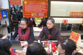 Khách hàng đang giao dịch vàng miếng. (Ảnh: Đức Duy/Vietnam+)