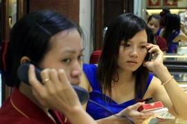 Khách hàng đang giao dịch vàng miếng. (Ảnh: TTXVN)