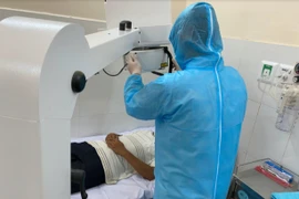 Nhân viên y tế làm các kỹ thuật chụp chiếu cho bệnh nhân. (Ảnh: TTXVN/Vietnam+)