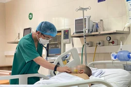 Bác sỹ thăm khám cho một bệnh nhân bị lóc động mạch chủ type A cấp tính sau phẫu thuật. (Ảnh: PV/Vietnam+)