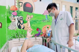 Bác sỹ thăm khám cho bệnh nhân sau phẫu thuật. (Ảnh: PV/Vietnam+)