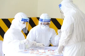 Nhân viên y tế làm công tác lấy mẫu xét nghiệm. (Ảnh: TTXVN/Vietnam+)