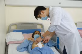 Bác sỹ thăm khám cho bệnh nhân sau phẫu thuật. (Ảnh: PV/Vietnam+)