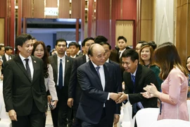 Chủ tịch nước Nguyễn Xuân Phúc đến dự buổi gặp gỡ cán bộ, nhân viên các cơ quan đại diện và đại diện cộng đồng người Việt Nam tại Indonesia. (Ảnh: Thống Nhất/TTXVN)