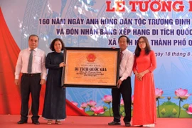 Đại diện Bộ Văn hóa, Thể thao và Du lịch cùng lãnh đạo tỉnh Quảng Ngãi trao Bằng xếp hạng Di tích Quốc gia Đền thờ Trương Định cho thành phố Quảng Ngãi và Ban Quản lý Đền thờ Trương Định. (Ảnh: Đinh Hương/TTXVN)