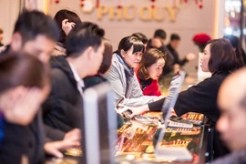 Khách hàng giao dịch vàng miếng. (Ảnh: Đức Duy/Vietnam+)