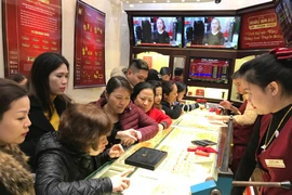 Khách hàng giao dịch vàng miếng. (Ảnh: Đức Duy/Vietnam+)