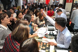 Khách hàng đang giao dịch vàng miếng. (Ảnh: Đức Duy/Vietnam+)