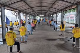 Công ty TNHH Compass II tại Bình Dương tổ chức test nhanh kiểm tra COVID-19 cho công nhân để kiểm soát đầu vào trước khi thực hiện '3 tại chỗ'. (Ảnh: Chí Tưởng/TTXVN)